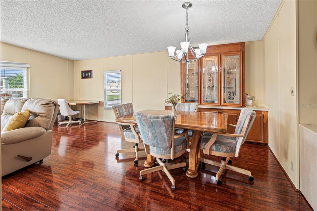 119 Mockingbird Lane Ellenton, FL 34222 - Photo 14 of 51 a view of a dining room with furniture wooden floor and chandelier