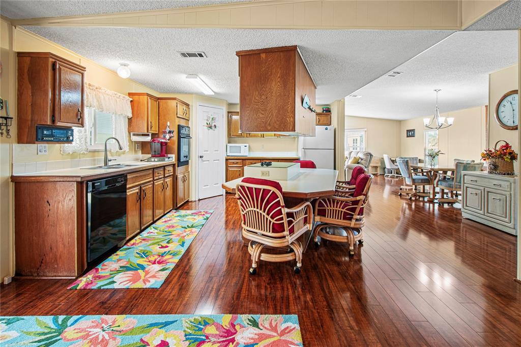 119 Mockingbird Lane Ellenton, FL 34222 - Photo 18 of 51 a very nice looking open dining room with kitchen island furniture and a wooden floor
