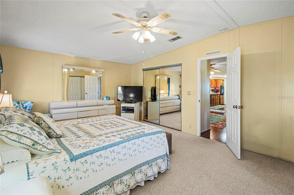 119 Mockingbird Lane Ellenton, FL 34222 - Photo 29 of 51 a bedroom with a large bed a flat tv screen and dresser
