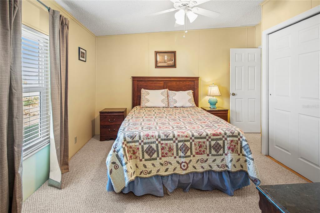 119 Mockingbird Lane Ellenton, FL 34222 - Photo 31 of 51 a bedroom with a bed and a chandelier