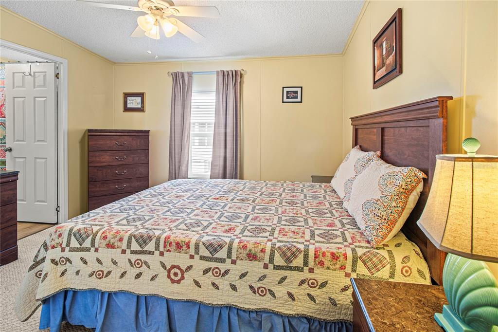 119 Mockingbird Lane Ellenton, FL 34222 - Photo 32 of 51 a bedroom with a bed and wooden floor