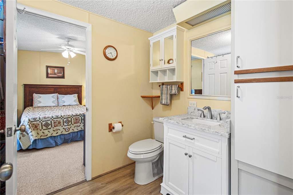 119 Mockingbird Lane Ellenton, FL 34222 - Photo 35 of 51 a bathroom with a granite countertop toilet sink and mirror