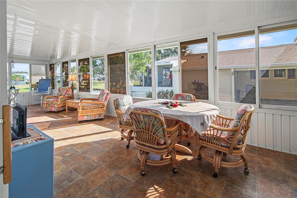 119 Mockingbird Lane Ellenton, FL 34222 - Photo 36 of 51 a dining room with furniture large windows and wooden floor