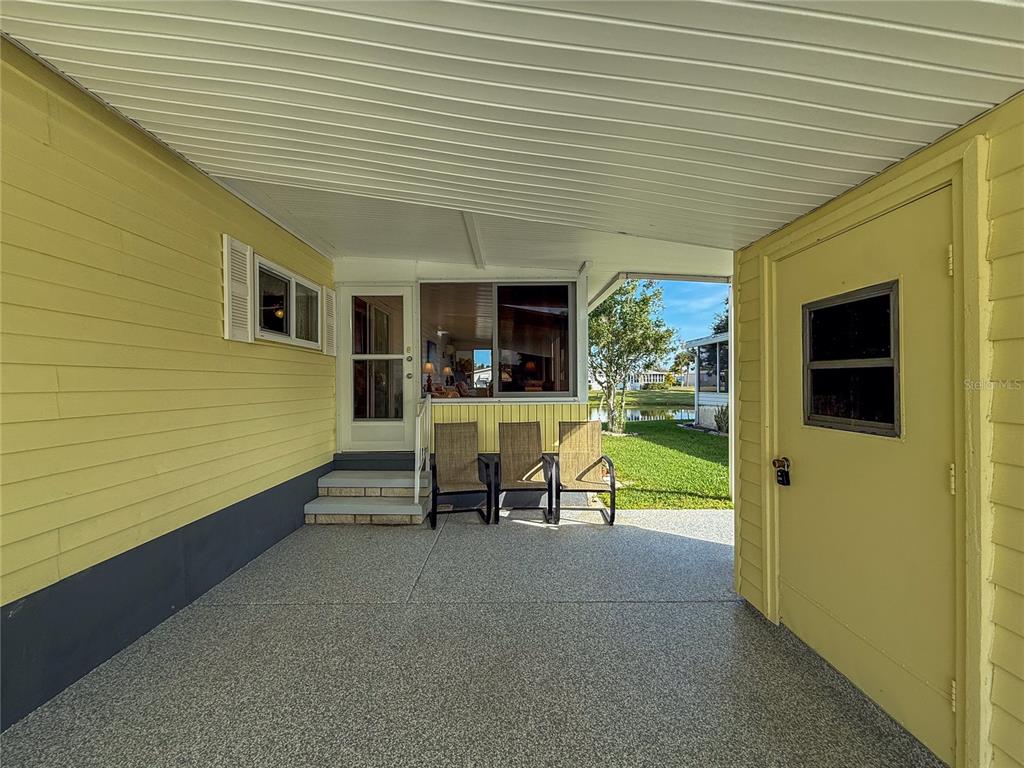 119 Mockingbird Lane Ellenton, FL 34222 - Photo 5 of 51 a view of a patio with a table and chairs under an umbrella