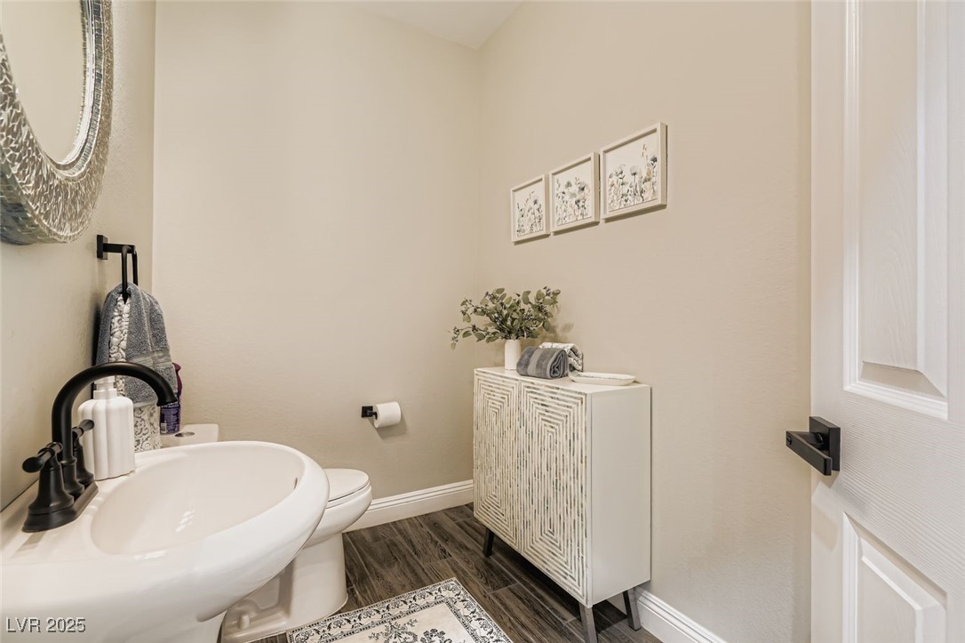 7055 Fort Tule Avenue Las Vegas, NV 89179 - Photo 15 of 75 Bathroom featuring baseboards custom mirror and cabinetry