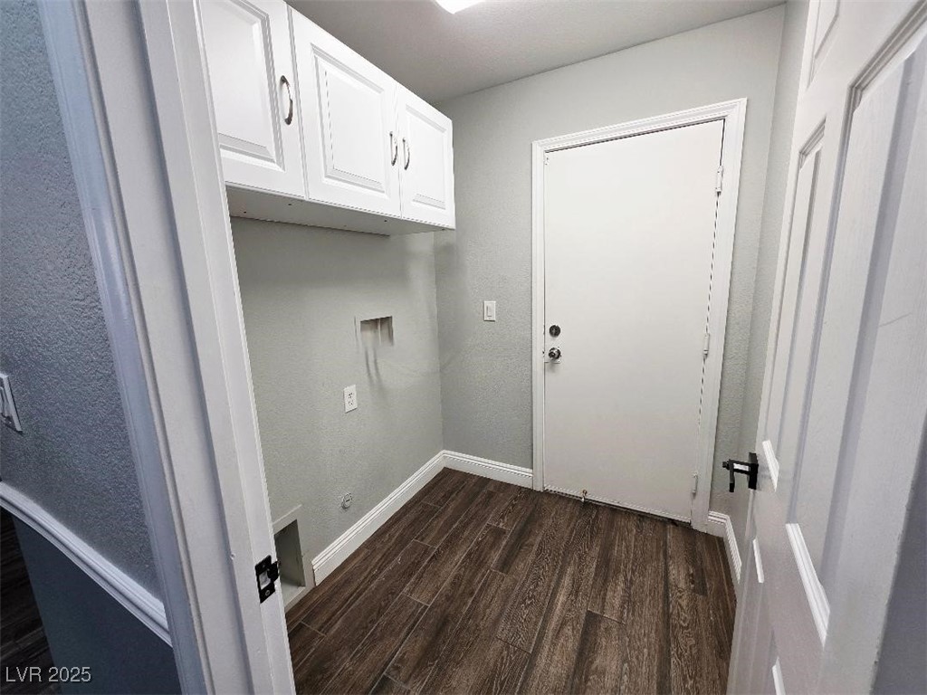7055 Fort Tule Avenue Las Vegas, NV 89179 - Photo 16 of 75 Laundry area featuring dark tile-style flooring, cabinet space, and hookup for a washing machine