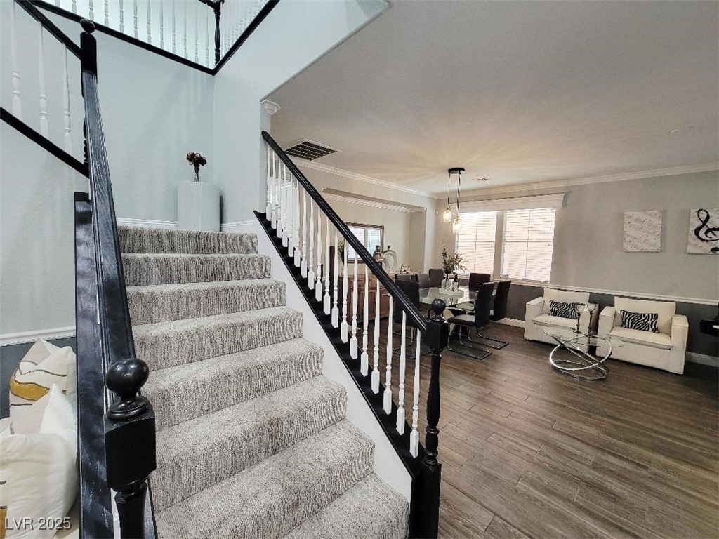 7055 Fort Tule Avenue Las Vegas, NV 89179 - Photo 22 of 75 Stairway with dark wood banister - molding plush deco carpet on stairs