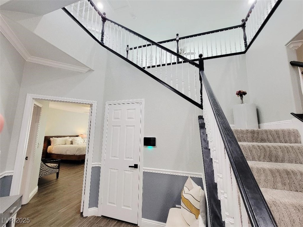 7055 Fort Tule Avenue Las Vegas, NV 89179 - Photo 23 of 75 Stairs featuring a high ceiling, view to down primary , crown and wall molding lots of storage