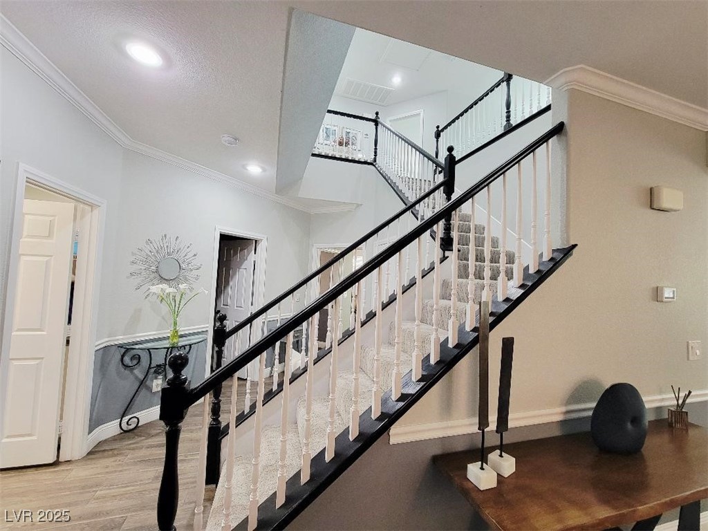 7055 Fort Tule Avenue Las Vegas, NV 89179 - Photo 24 of 75 Staircase featuring crown molding, and recessed lighting