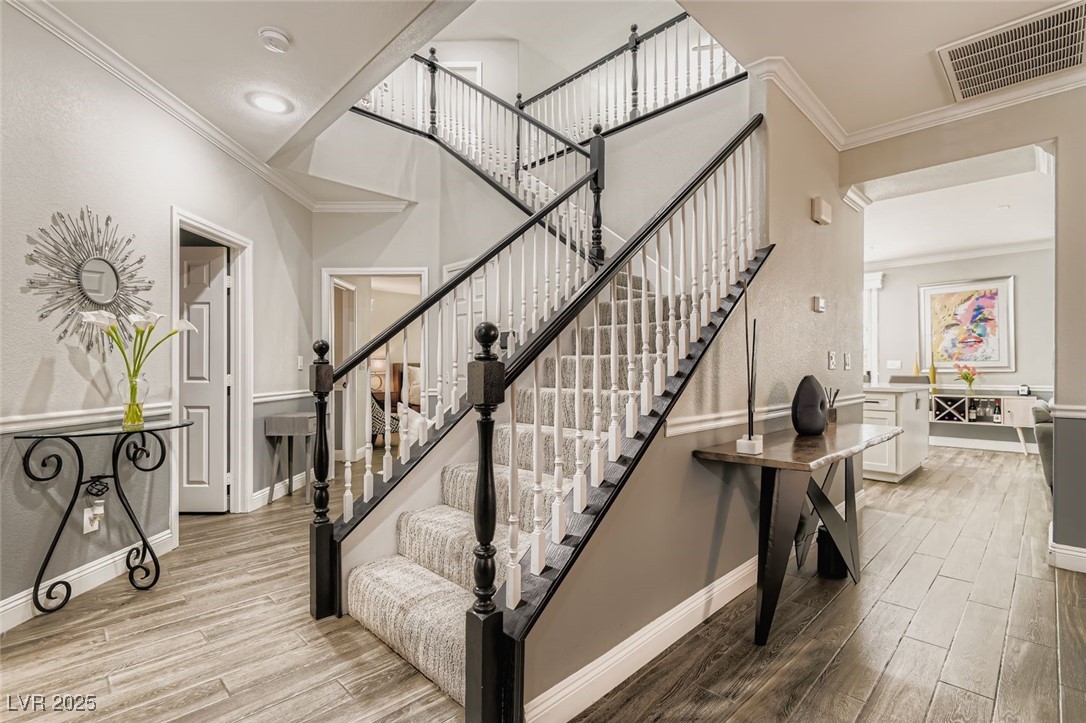7055 Fort Tule Avenue Las Vegas, NV 89179 - Photo 25 of 75 Stairs with crown molding and tile finished floors