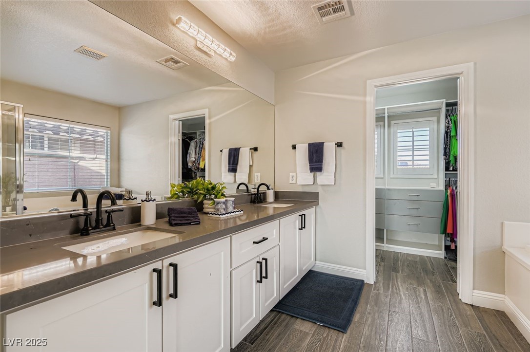 7055 Fort Tule Avenue Las Vegas, NV 89179 - Photo 29 of 75 Full bathroom featuring a spacious closet, a garden tub, tile flooring, all new double vanity