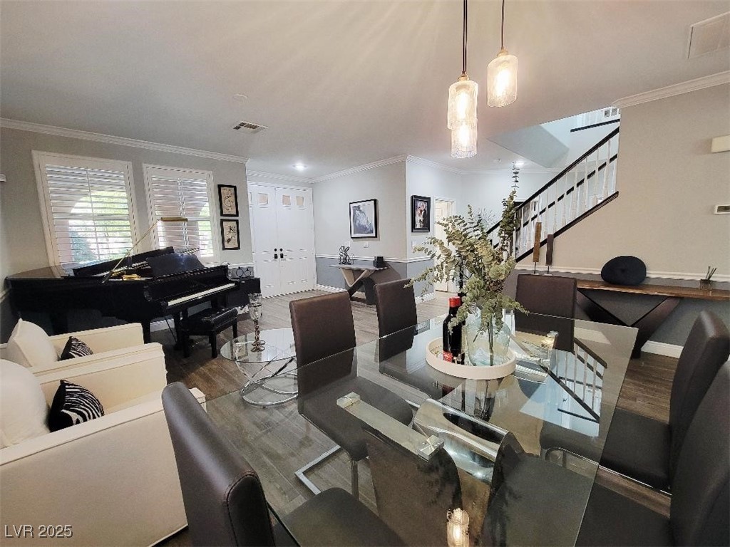 7055 Fort Tule Avenue Las Vegas, NV 89179 - Photo 4 of 75 Dining space with crown molding, tile finished floors, stairs, and recessed and lighting