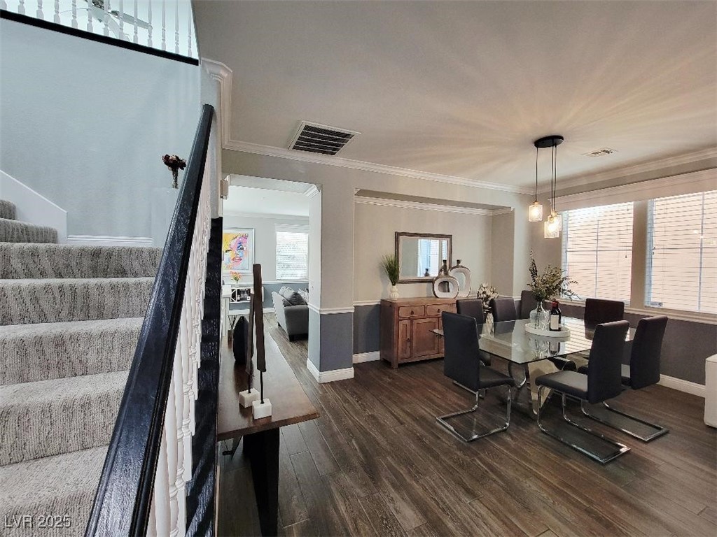 7055 Fort Tule Avenue Las Vegas, NV 89179 - Photo 6 of 75 Dining space with Split stairs, tile floors, and crown molding, deco lights
