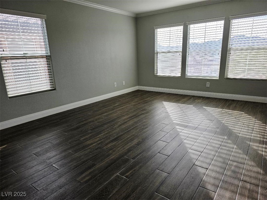 7055 Fort Tule Avenue Las Vegas, NV 89179 - Photo 65 of 75 room with crown molding, dark tile finished floors, and healthy amount of natural light 2nd floor