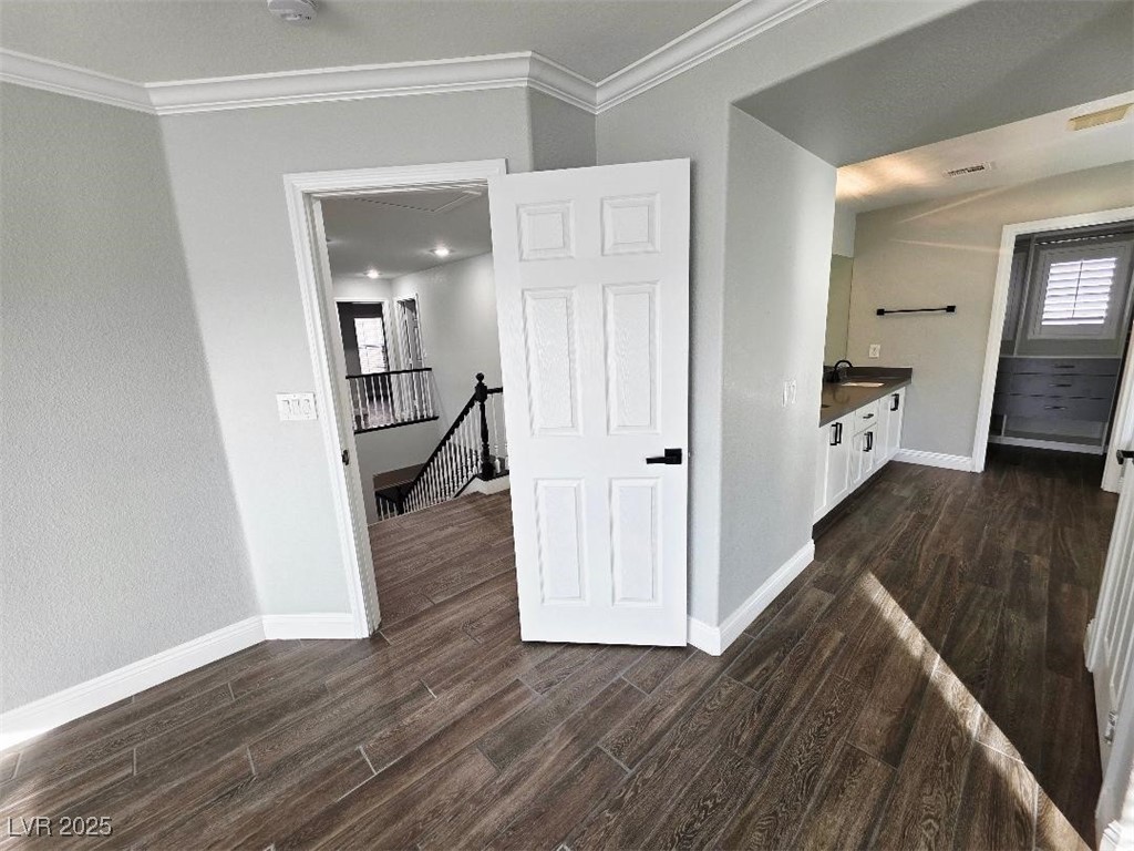7055 Fort Tule Avenue Las Vegas, NV 89179 - Photo 68 of 75 Bathroom with vanity, dark tile finished floors, and ornamental molding 2nd primary up