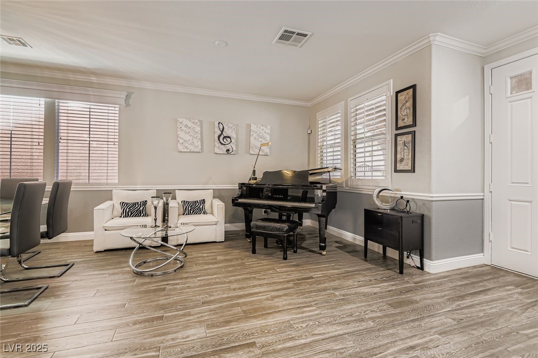 7055 Fort Tule Avenue Las Vegas, NV 89179 - Photo 7 of 75 Living area featuring crown molding and light tile flooring