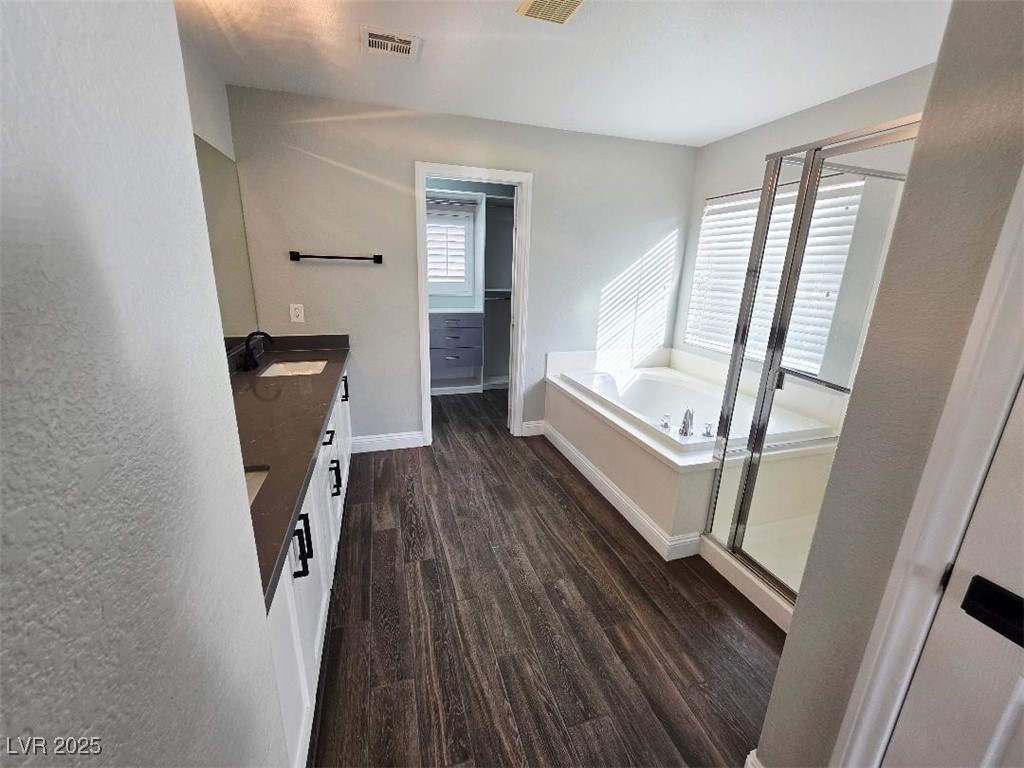 7055 Fort Tule Avenue Las Vegas, NV 89179 - Photo 70 of 75 Bathroom with vanity, dark tile flooring, a stall shower, a garden tub, and a walk in closet 2nd floor