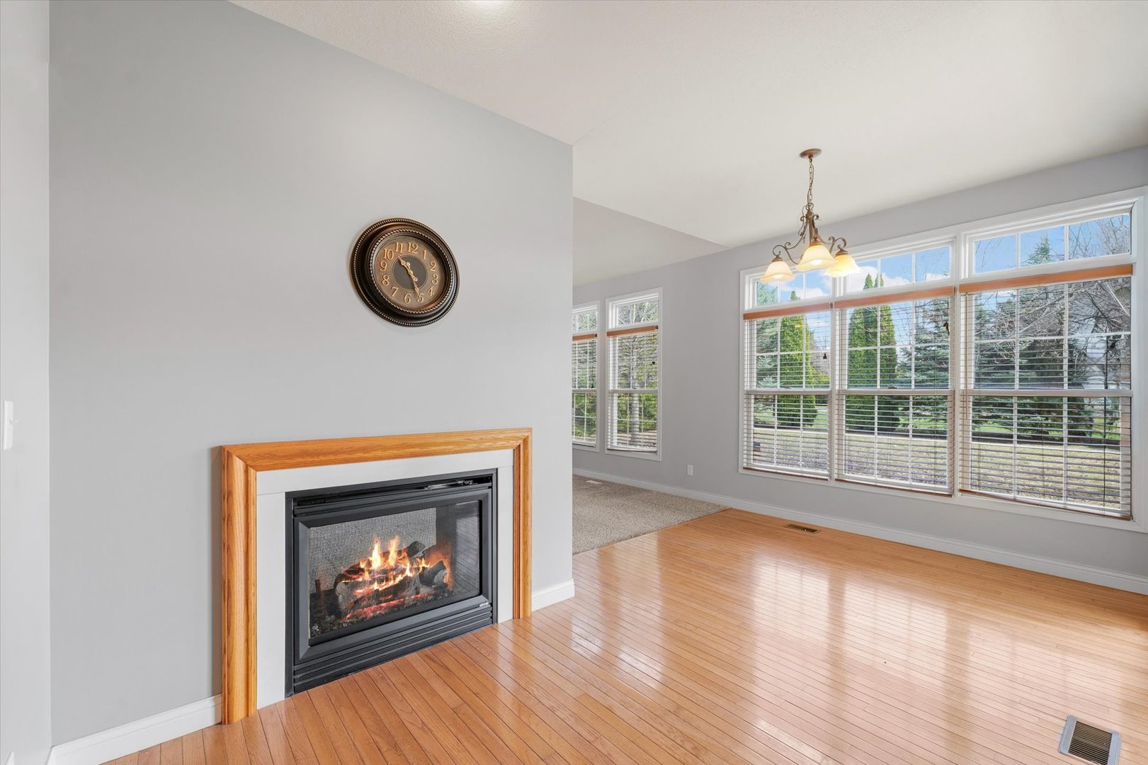1818 Benodot Street Champaign, IL 61822 - Photo 13 of 41 a view of an empty room with wooden floor and a fireplace