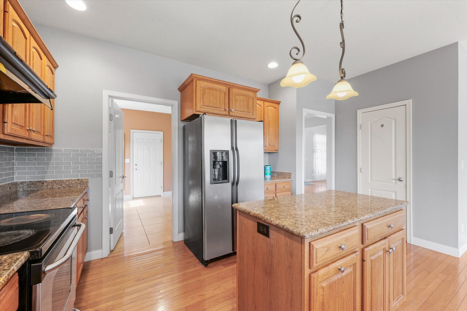 1818 Benodot Street Champaign, IL 61822 - Photo 10 of 41 a kitchen with stainless steel appliances granite countertop a refrigerator a sink and a stove