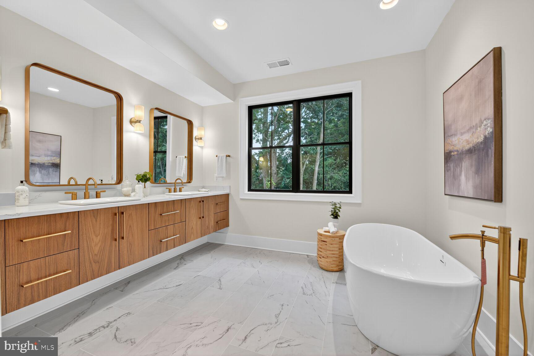 4812 Chevy Chase Boulevard Chevy Chase, MD 20815 - Photo 15 of 32 a bathroom with a tub a sink and mirror