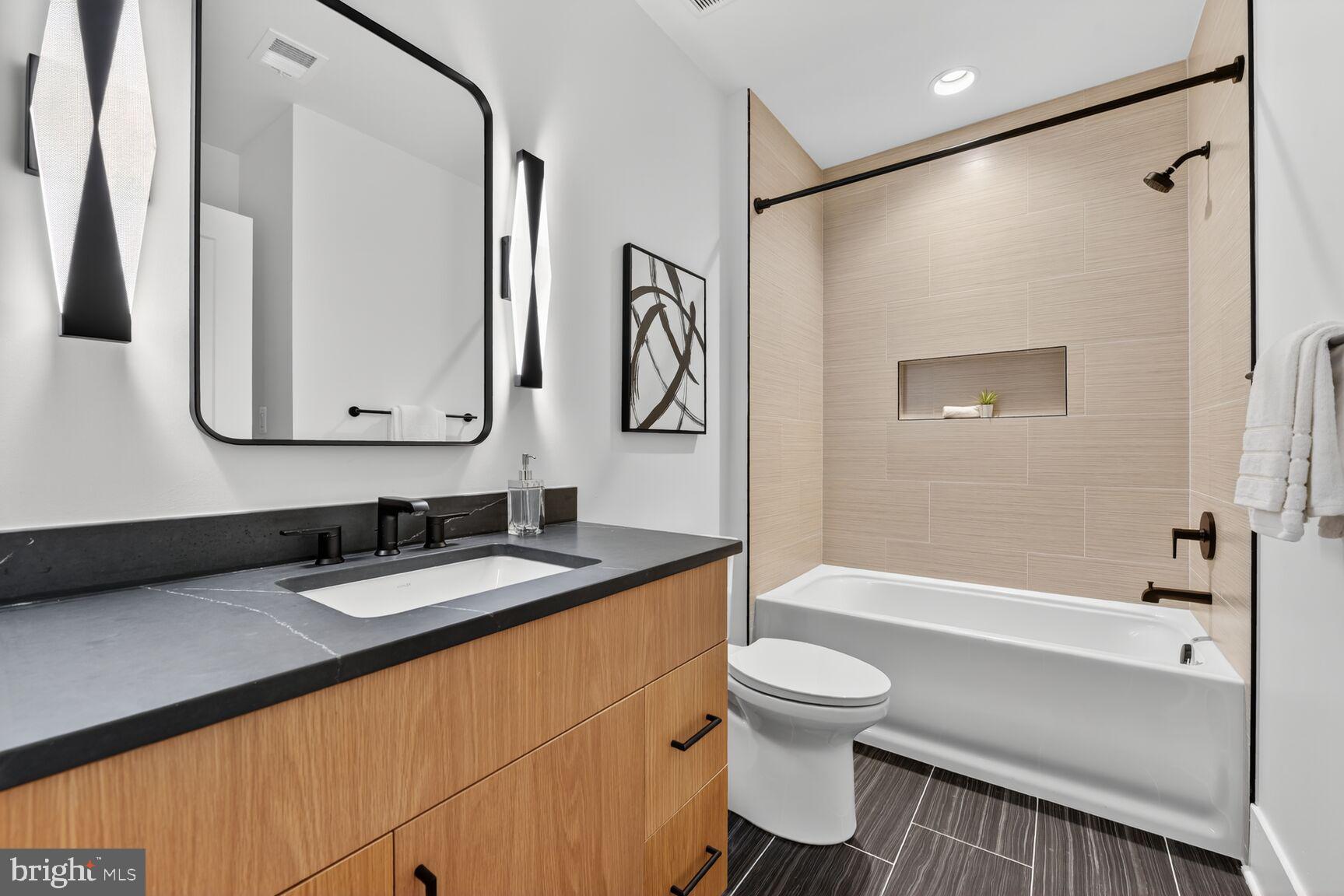 4812 Chevy Chase Boulevard Chevy Chase, MD 20815 - Photo 17 of 32 a bathroom with a sink a toilet and a mirror