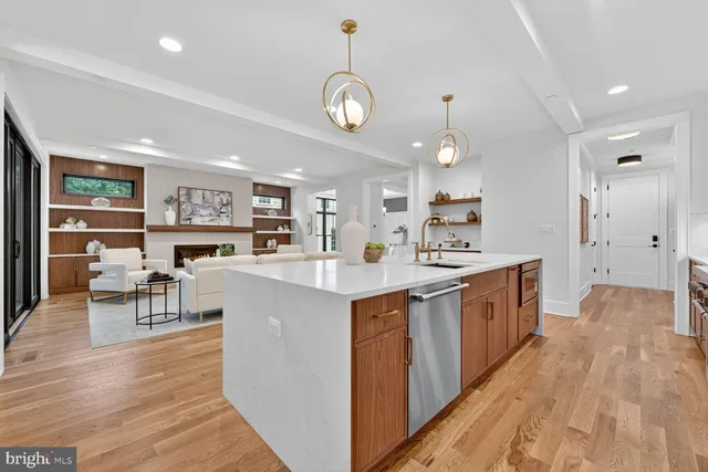 a dining room with wooden floor a chandelier a wooden table and chairs