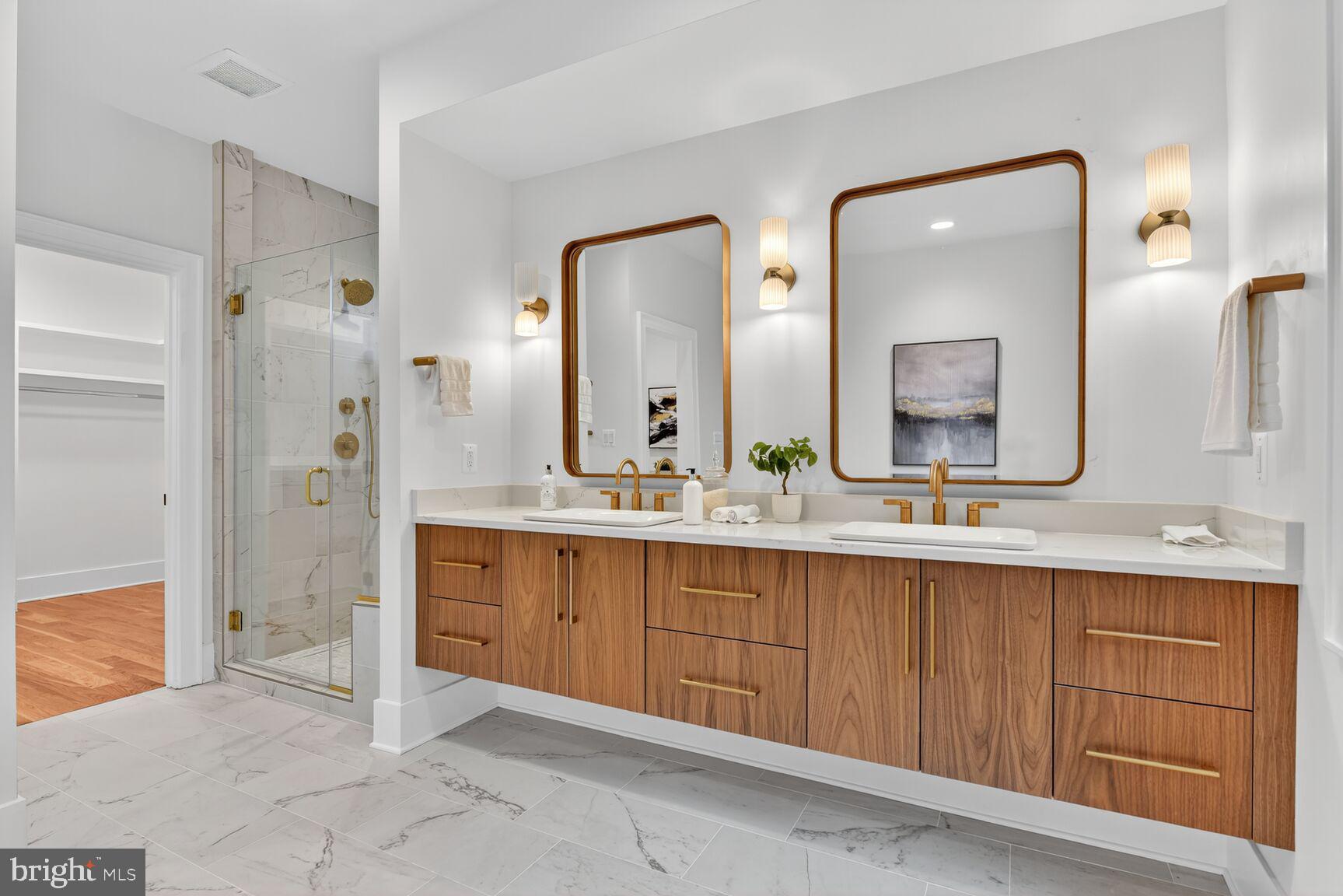 4812 Chevy Chase Boulevard Chevy Chase, MD 20815 - Photo 21 of 32 a spacious bathroom with a double vanity sink and a mirror