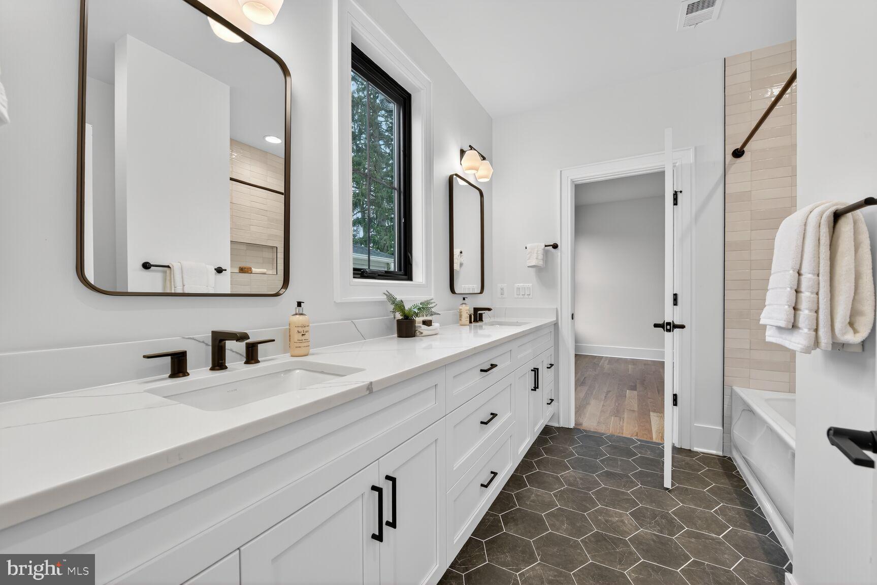 4812 Chevy Chase Boulevard Chevy Chase, MD 20815 - Photo 23 of 32 a bathroom with a double vanity sink mirror and double