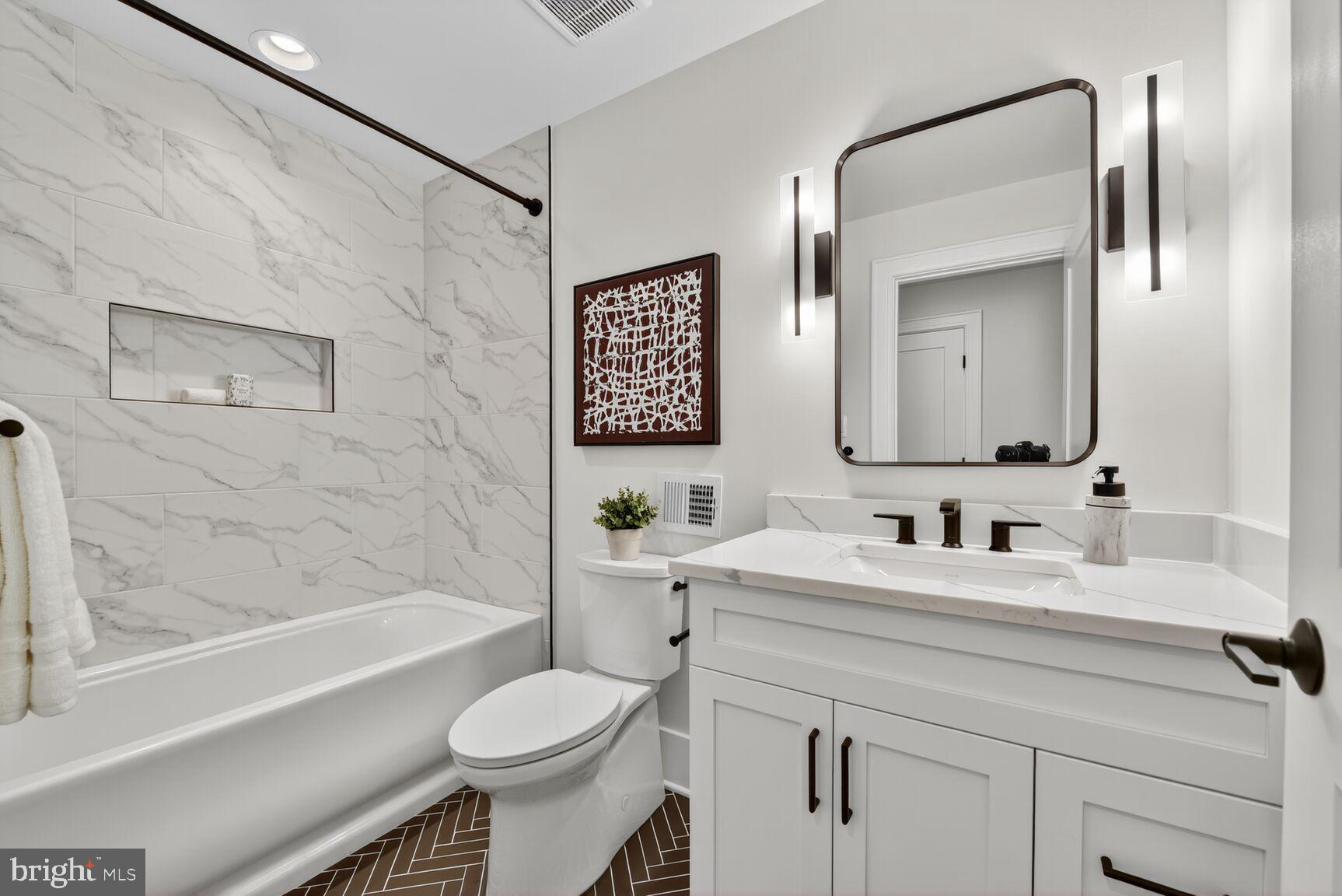 4812 Chevy Chase Boulevard Chevy Chase, MD 20815 - Photo 26 of 32 a bathroom with a toilet sink and a bathtub