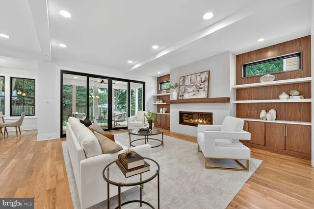 a living room with furniture fireplace and large window