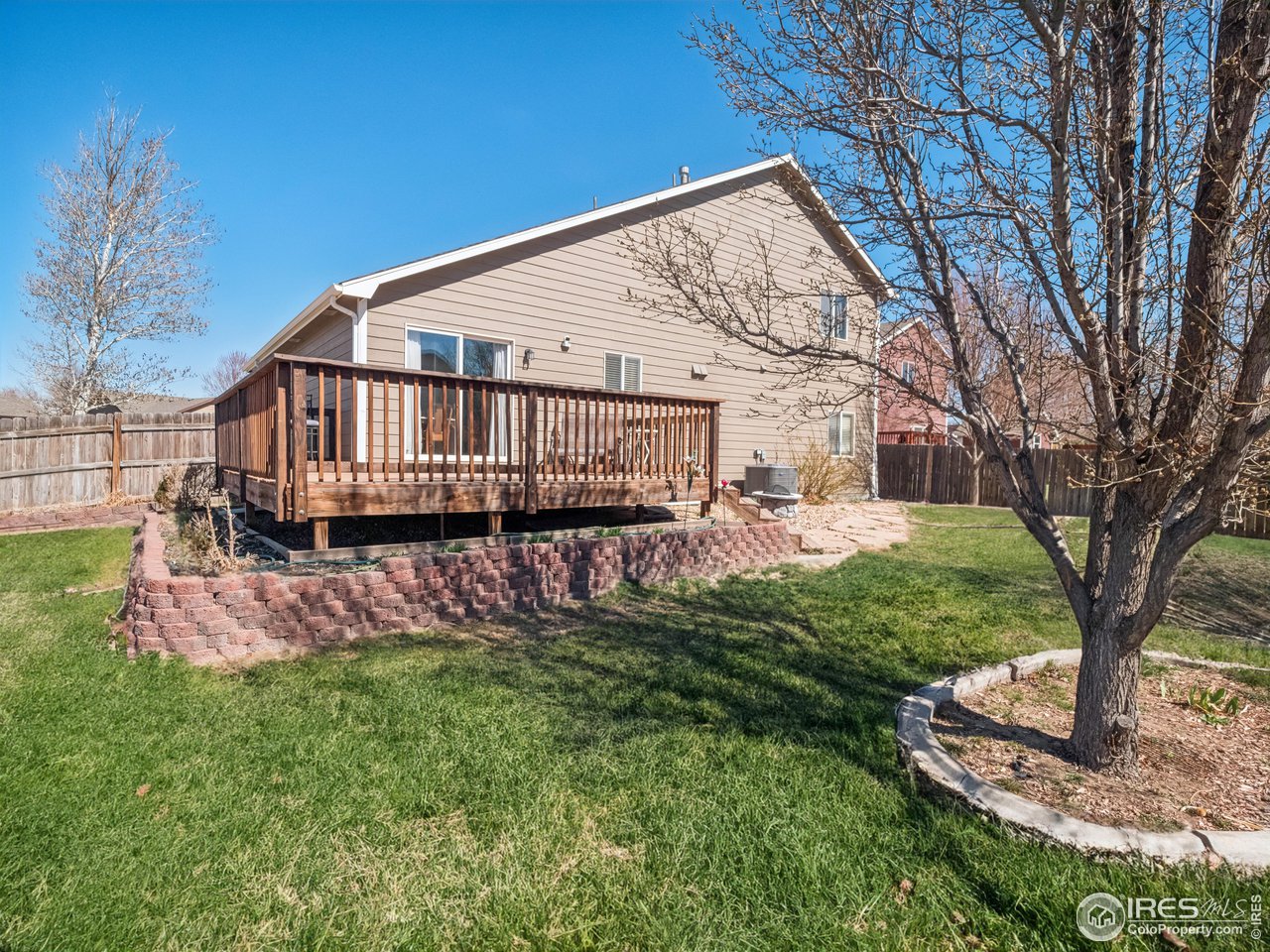 4050 West 30th Street Road Greeley, CO 80634 - Photo 28 of 37 Expansive backyard with shade trees! (grass edited for season and marketing purposes)