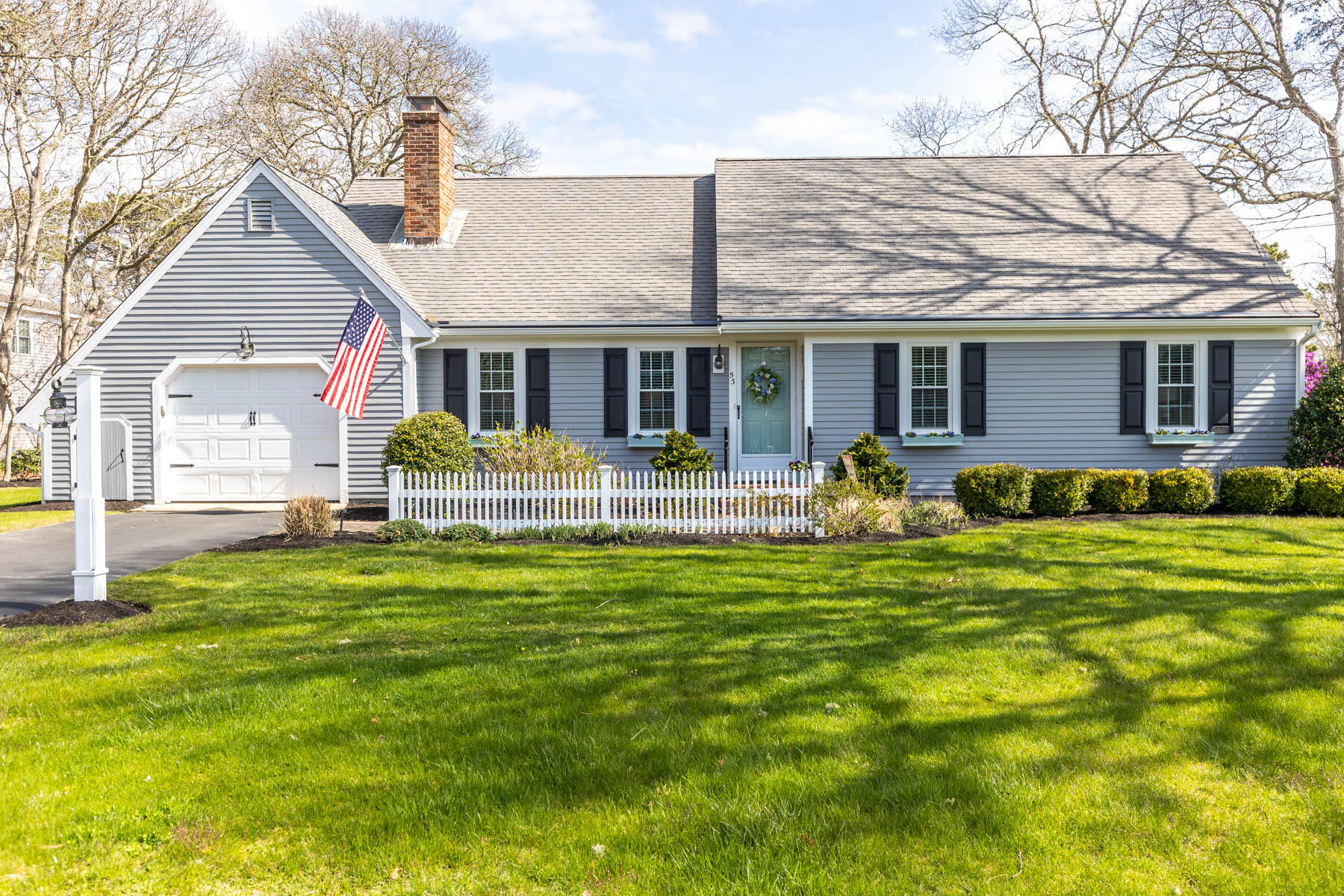 a front view of house with yard and green space