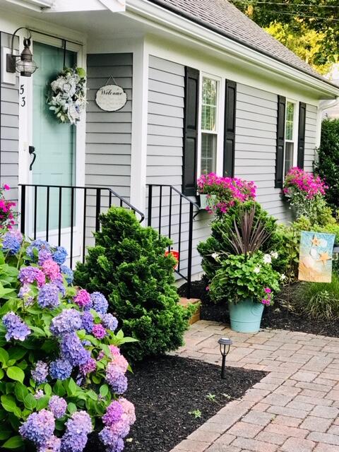 53 Kelley Road West Harwich, MA 02671 - Photo 36 of 43 a potted plant sitting in front of a house