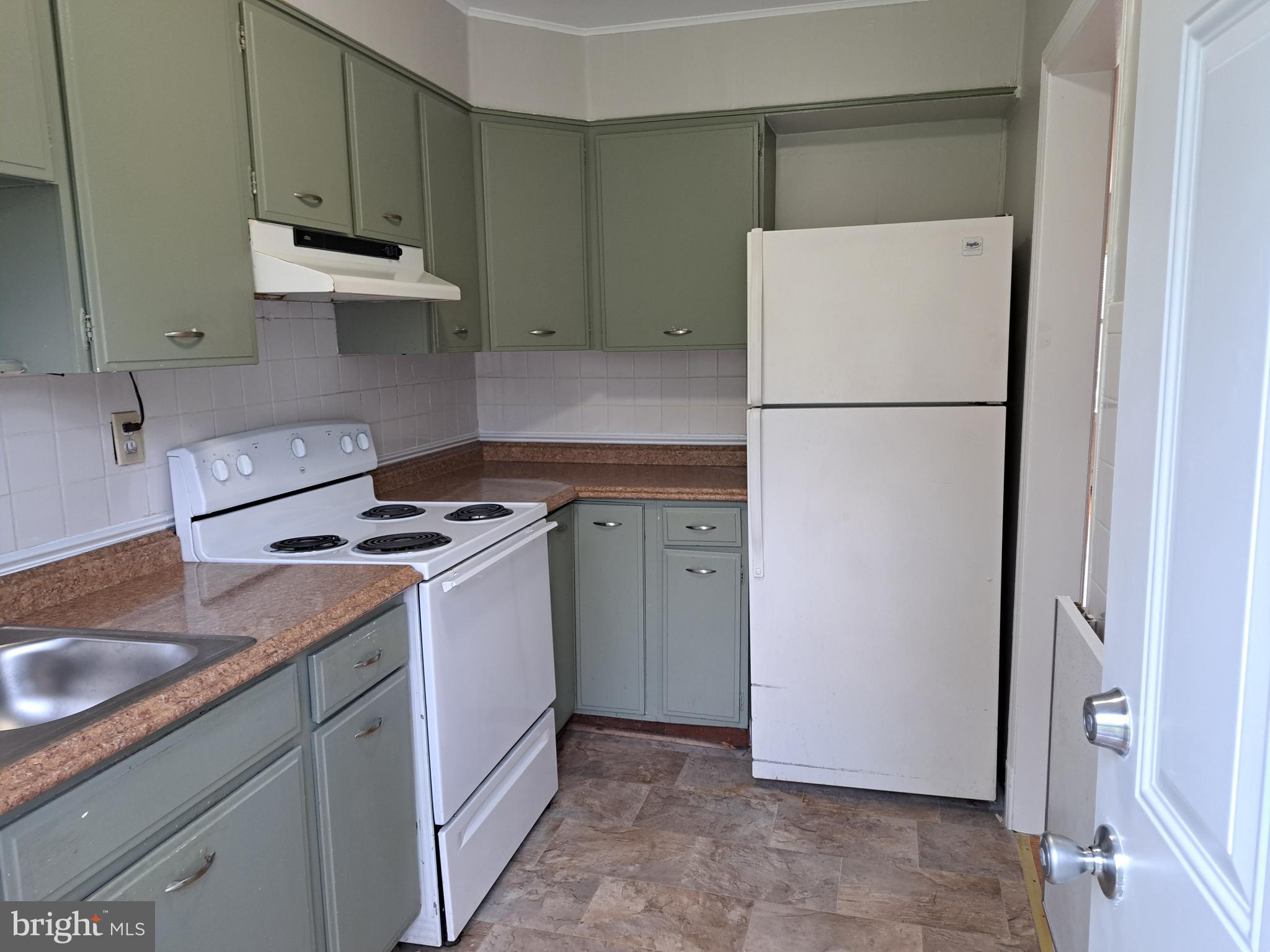 415 Biggs Avenue, Unit 1 Frederick, MD 21702 - Photo 12 of 29 a kitchen with a refrigerator sink stove and cabinets