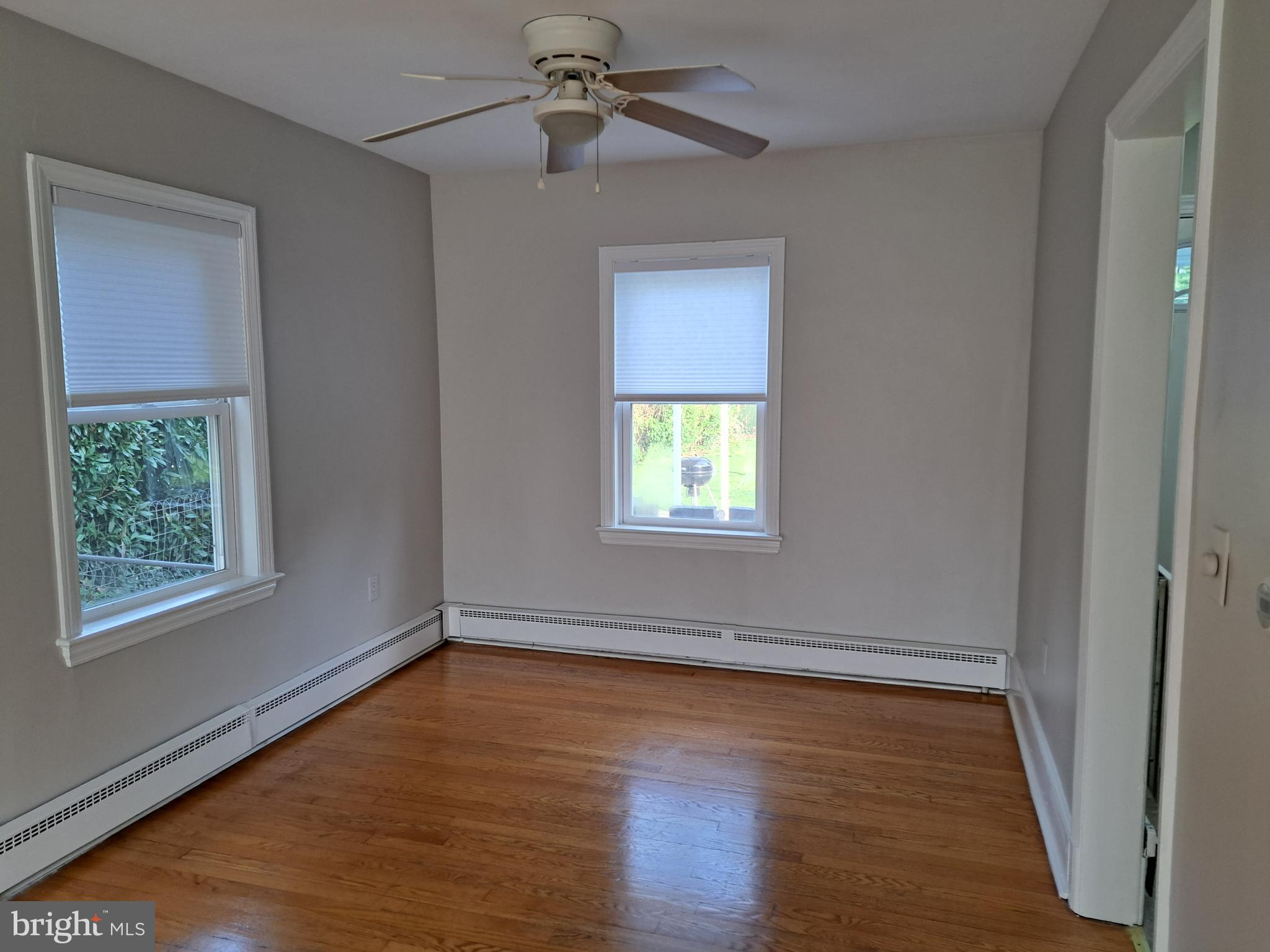 415 Biggs Avenue, Unit 1 Frederick, MD 21702 - Photo 2 of 29 a view of an empty room with wooden floor and a window