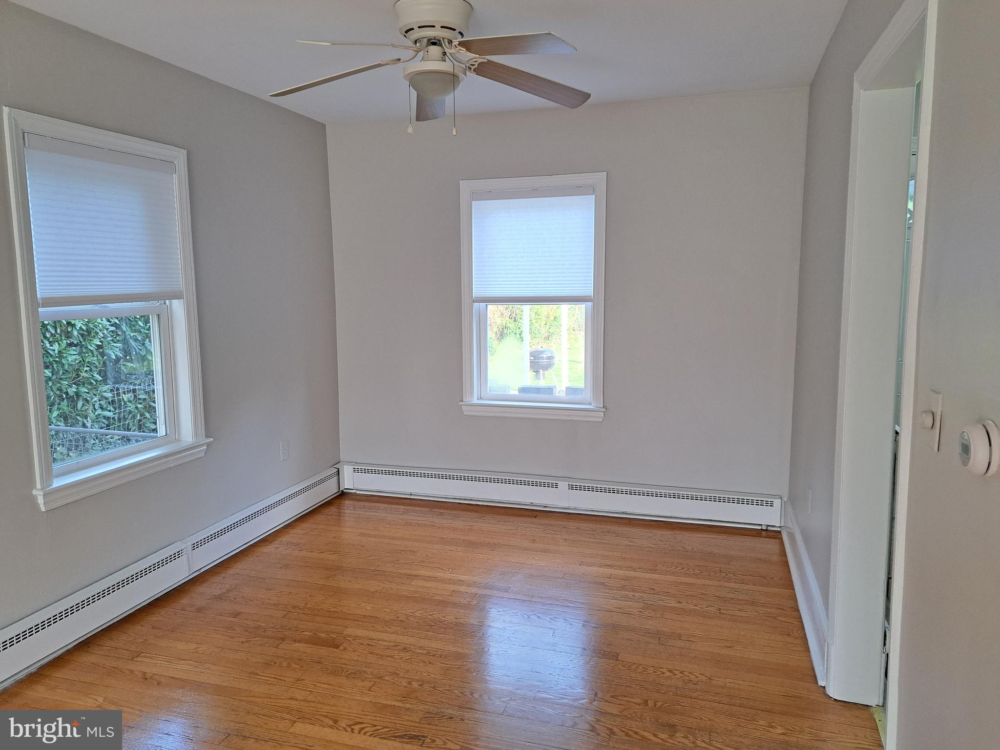 415 Biggs Avenue, Unit 1 Frederick, MD 21702 - Photo 3 of 29 a view of an empty room with wooden floor and a window