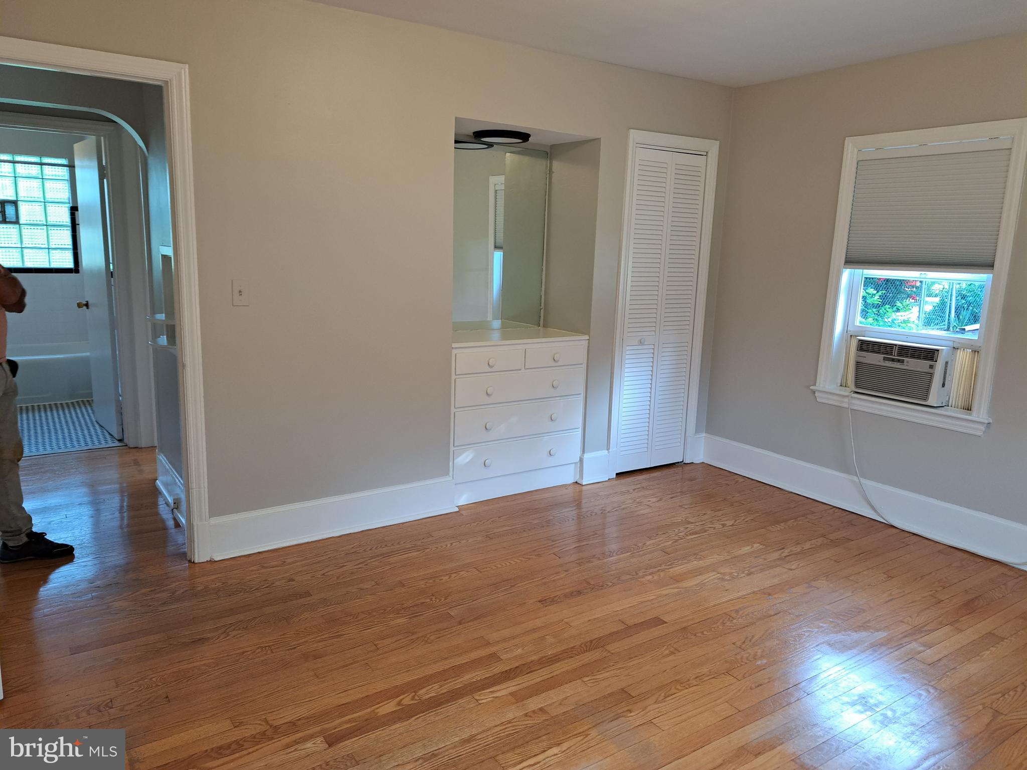 415 Biggs Avenue, Unit 1 Frederick, MD 21702 - Photo 5 of 29 a view of an empty room with wooden floor and a window