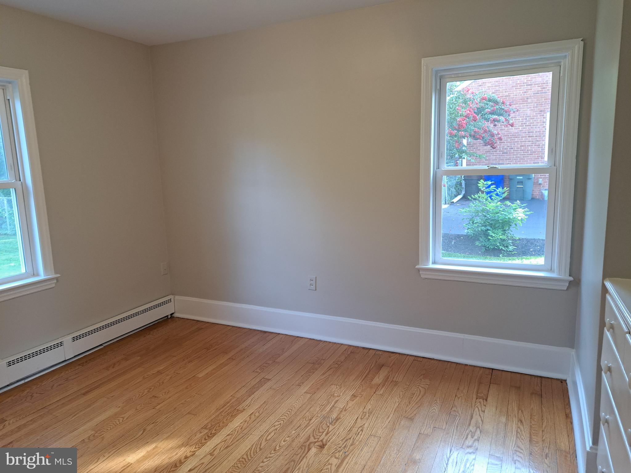 415 Biggs Avenue, Unit 1 Frederick, MD 21702 - Photo 7 of 29 a view of room with window and wooden floor