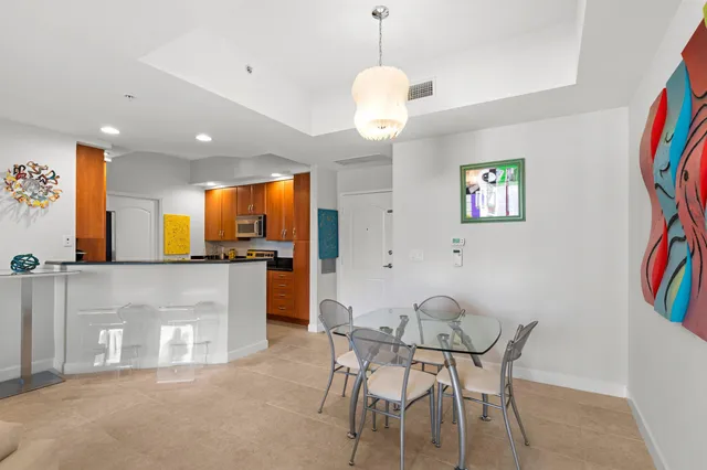 a view of a dining room with furniture and a chandelier