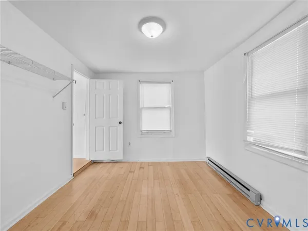 wooden floor in an empty room with a window