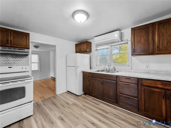 a kitchen with stainless steel appliances granite countertop a stove a microwave and a sink