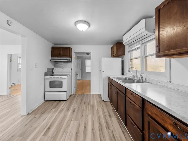 a kitchen with stainless steel appliances granite countertop a sink stove microwave and refrigerator