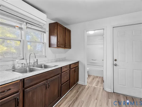 a spacious bathroom with a double vanity sink a mirror and a shower