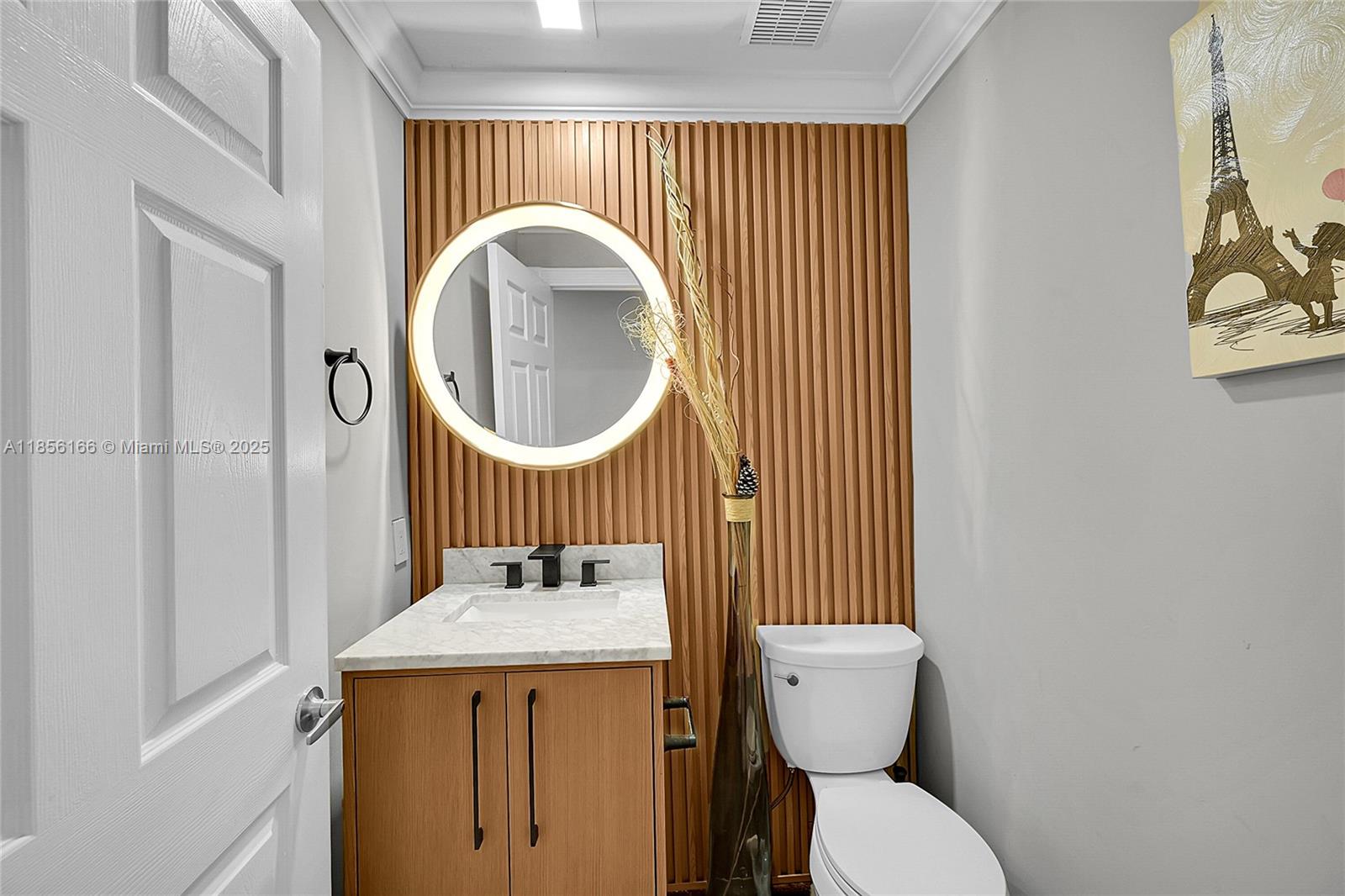 9398 Aegean Drive Boca Raton, FL 33496 - Photo 12 of 61 a bathroom with a toilet a sink and a mirror