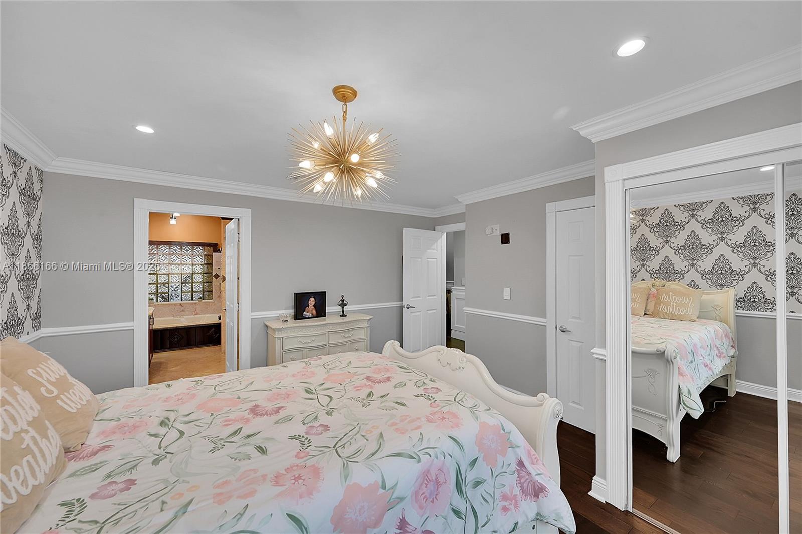9398 Aegean Drive Boca Raton, FL 33496 - Photo 23 of 61 a bedroom with a large bed and a chandelier