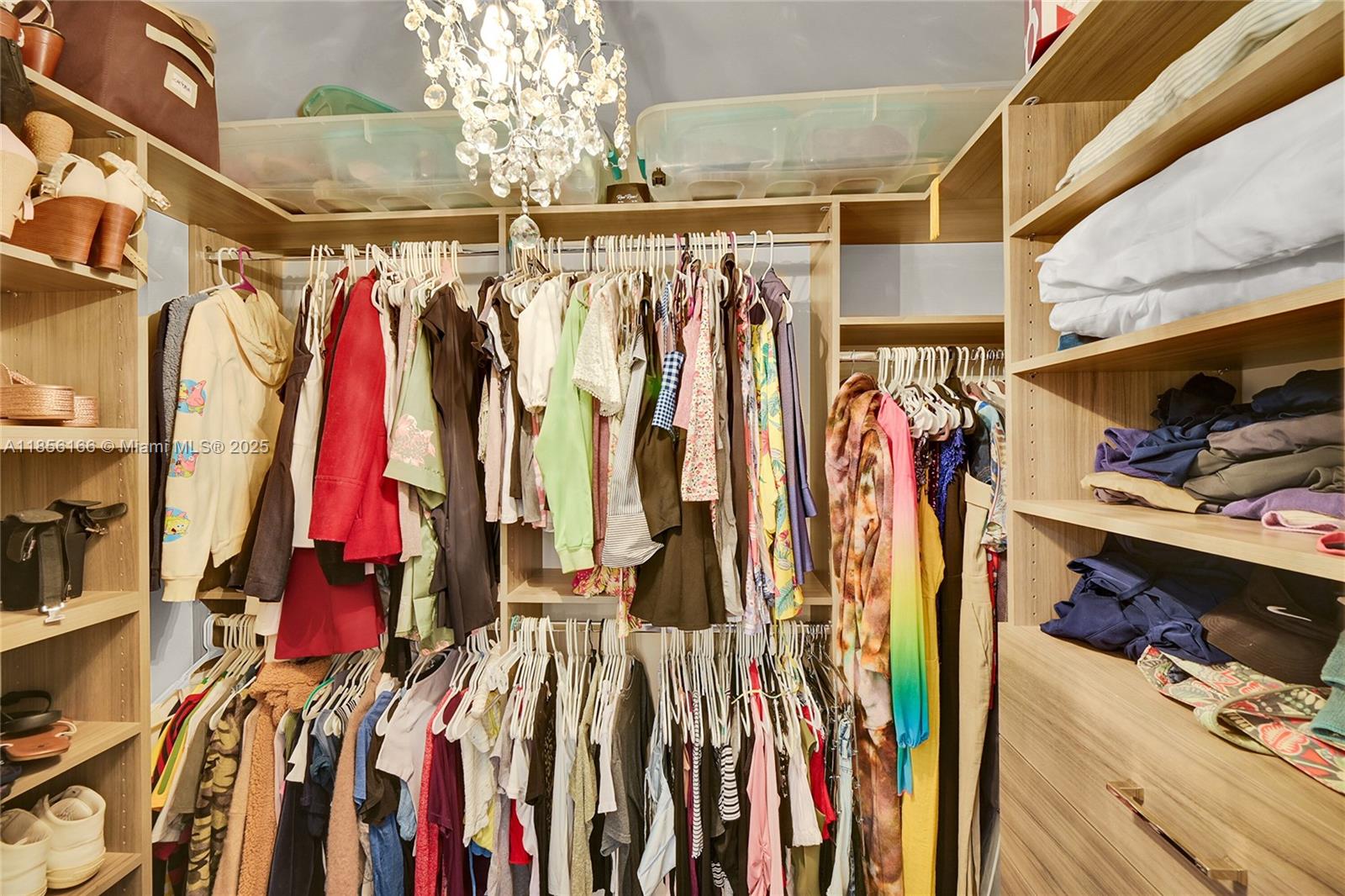 9398 Aegean Drive Boca Raton, FL 33496 - Photo 24 of 61 a view of walk in closet with clothes