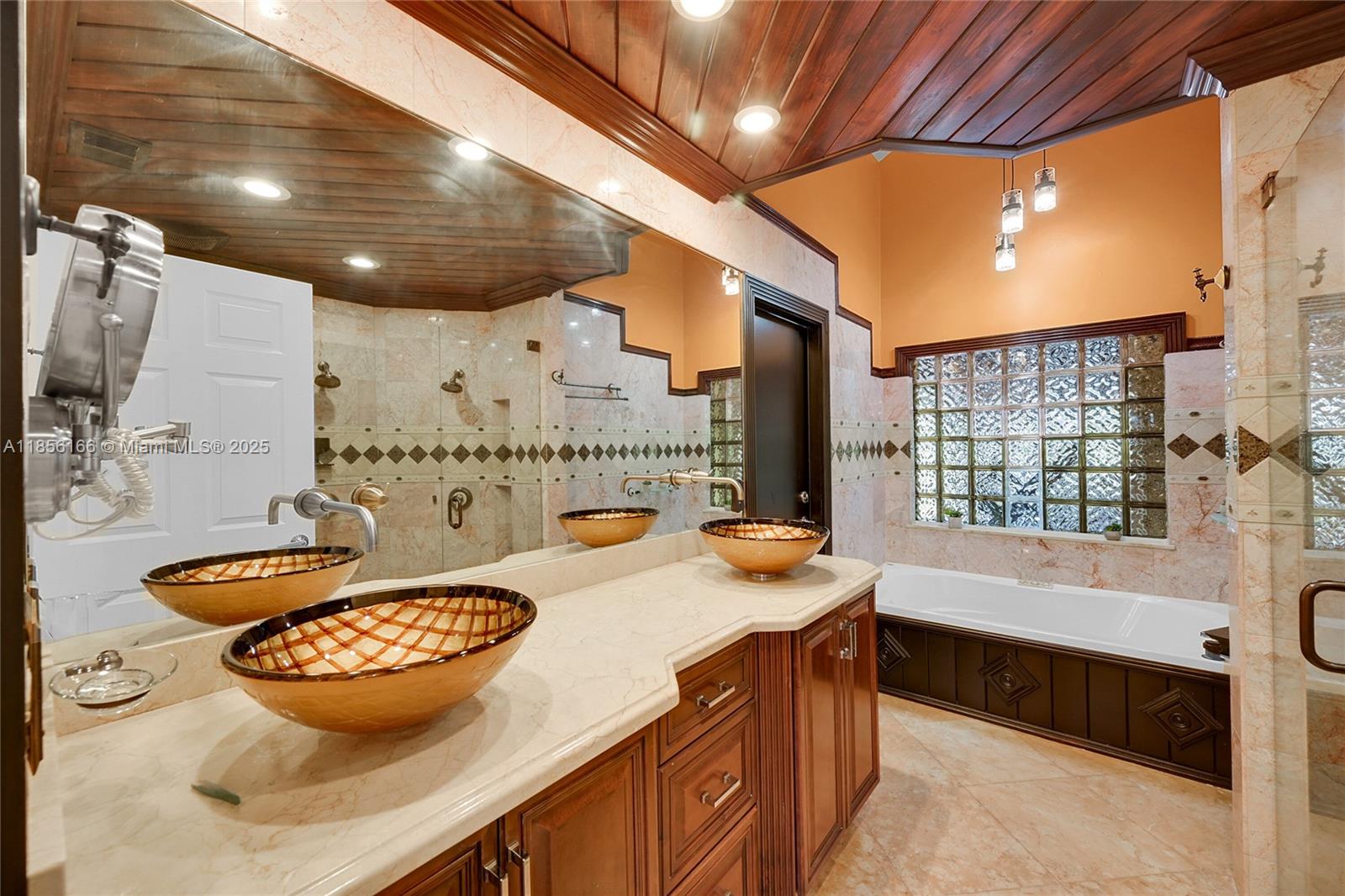 9398 Aegean Drive Boca Raton, FL 33496 - Photo 25 of 61 a bathroom with a tub sink and mirror