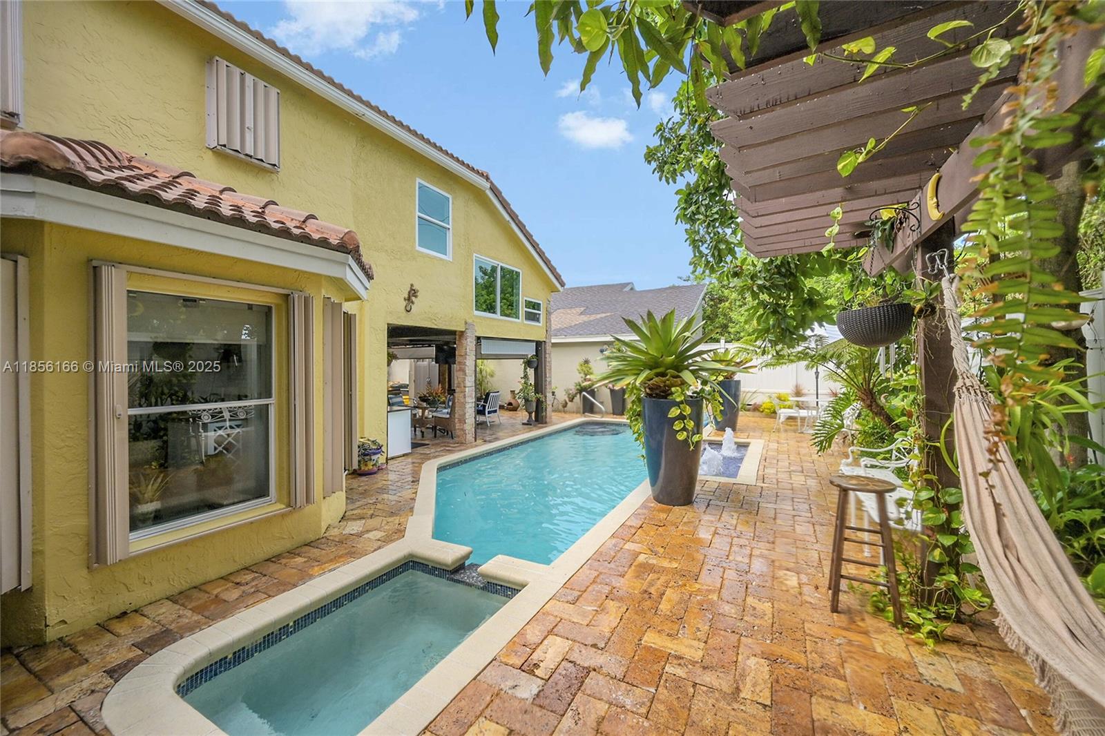 9398 Aegean Drive Boca Raton, FL 33496 - Photo 40 of 61 a view of a potted plants in front of a building