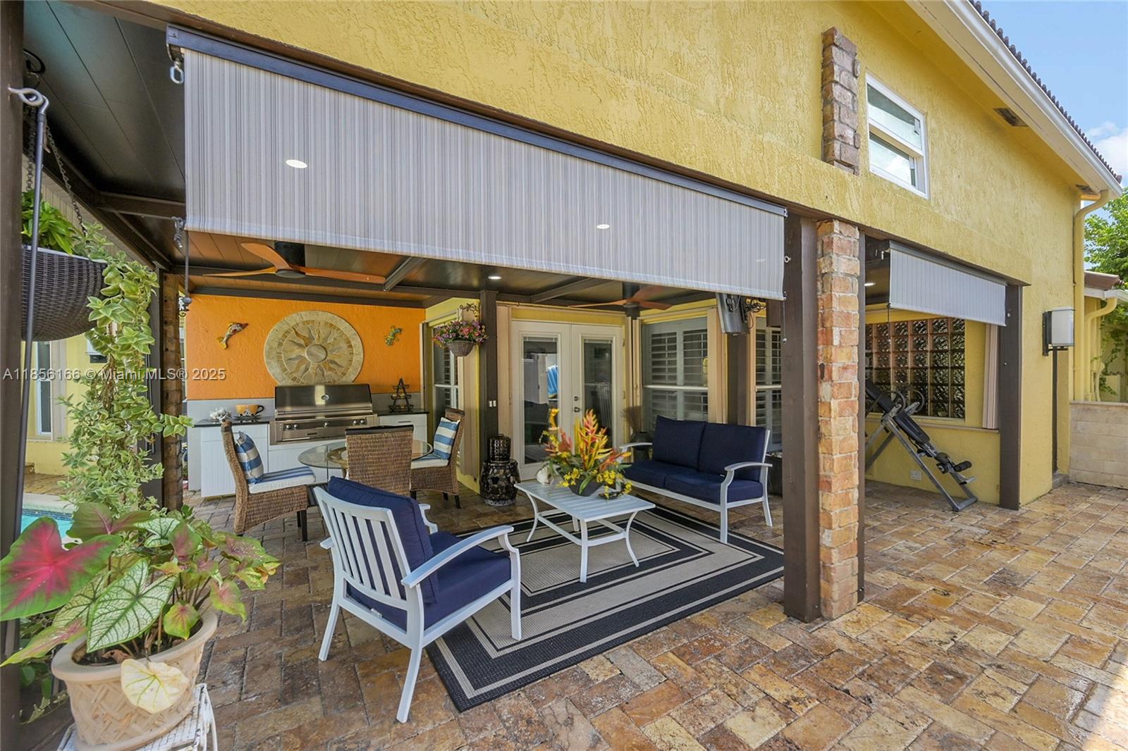 9398 Aegean Drive Boca Raton, FL 33496 - Photo 46 of 61 a view of a patio with table and chairs and potted plants
