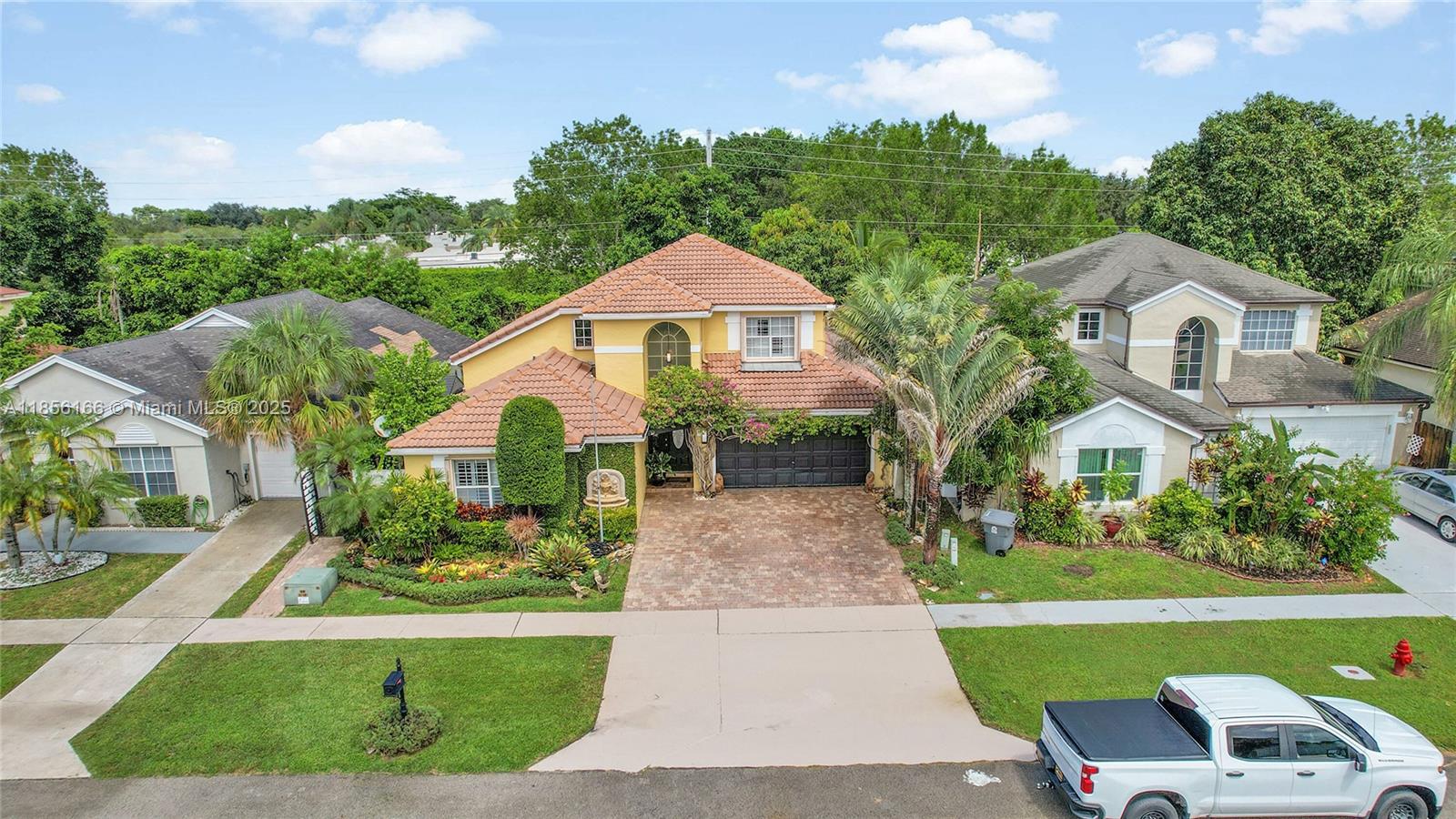9398 Aegean Drive Boca Raton, FL 33496 - Photo 51 of 61 a front view of house with yard and green space